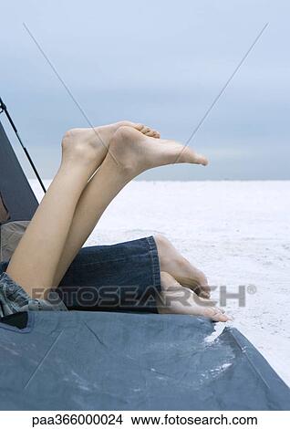 Picture - Campers on beach, view of legs. Fotosearch