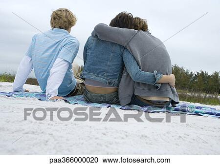 Friends sitting on beach View Large Photo Image Stock Image - Friends sitting on beach. Fotosearch