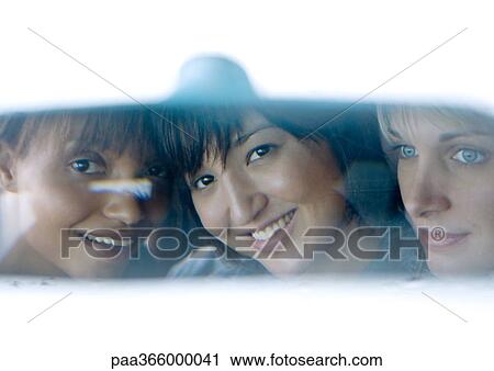 Young adult female friends seen in rear view mirror View Large Photo Image Stock Image - Young adult female friends seen in rear view mirror. Fotosearch