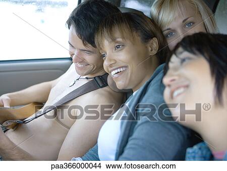 Young adult friends in car together View Large Photo Image Picture - Young adult friends in car together. Fotosearch