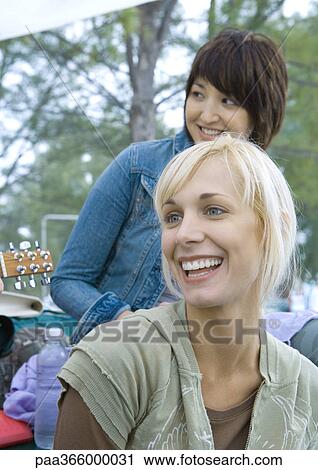 Stock Image - Young adult friends outdoors. Fotosearch