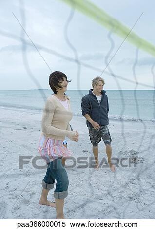 Young adult friends playing beach volleyball View Large Photo Image Stock Photography - Young adult friends playing beach volleyball. Fotosearch