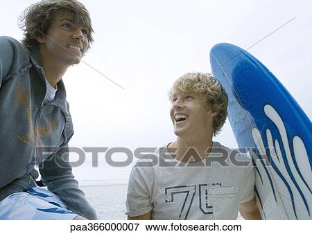 Young men with surfboard View Large Photo Image Stock Photo - Young men with surfboard. Fotosearch