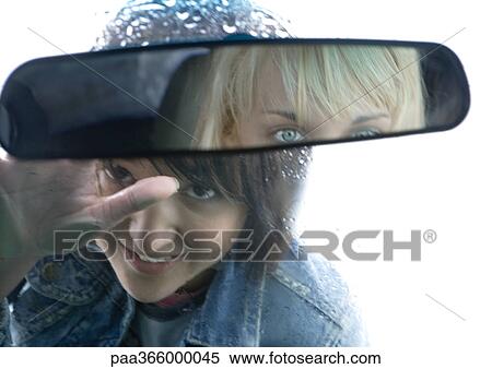Young woman looking through windshield at female friend View Large Photo Image Stock Photography - Young woman looking through windshield at female friend. Fotosearch