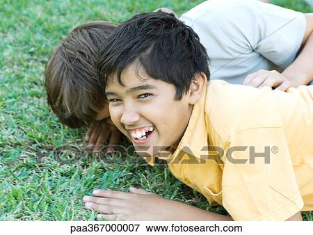 Preteen boys on ground, laughing View Large Photo Image Stock Photo - Preteen boys on ground, laughing. Fotosearch