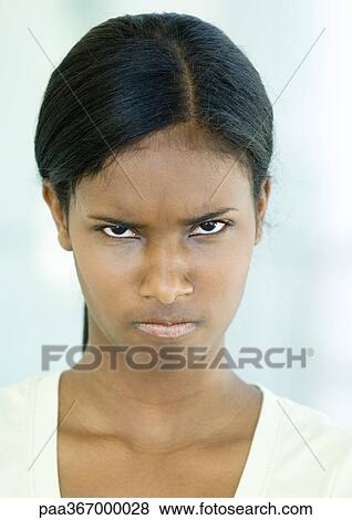 Stock Photo - Teen girl frowning, portrait. Fotosearch