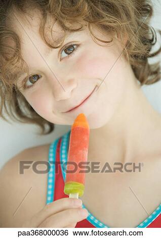 Stock Photograph - Girl with popsicle, portrait. Fotosearch