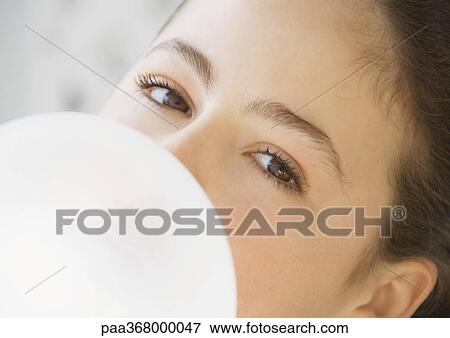 Stock Photo - Preteen girl blowing bubble . Fotosearch
