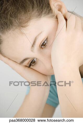 Preteen girl holding head, looking down View Large Photo Image Stock Photo - Preteen girl holding head, looking down. Fotosearch