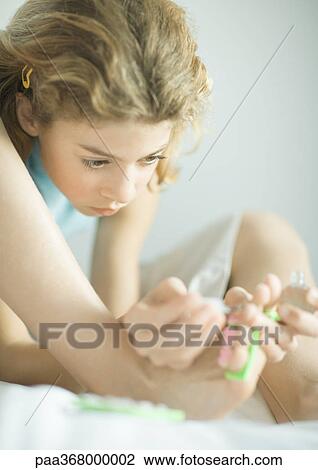 Preteen girl painting toenails View Large Photo Image Stock Image - Preteen girl painting toenails. Fotosearch