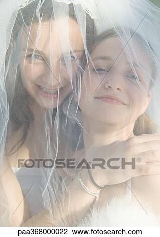 Preteen girls behind wedding veil View Large Photo Image Stock Image - Preteen girls behind wedding veil. Fotosearch