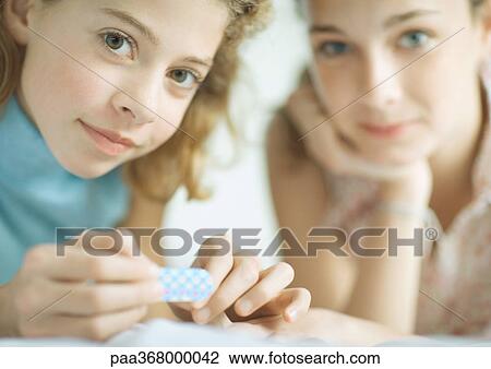 Preteen girls filing nails View Large Photo Image Stock Image - Preteen girls filing nails. Fotosearch