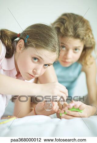 Preteen girls painting toenails View Large Photo Image Stock Image - Preteen girls painting toenails. Fotosearch