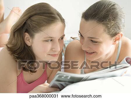 Preteen girls reading magazine together View Large Photo Image Stock Image - Preteen girls reading magazine together. Fotosearch