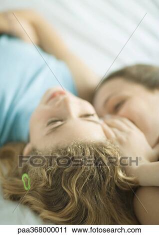 Stock Image - Preteen girls whispering. Fotosearch