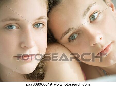 Two preteen girls, one with head on other's shoulder View Large Photo Image Stock Photo - Two preteen girls, one with head on other's shoulder. Fotosearch