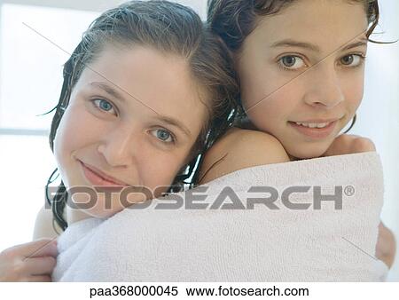 Two preteen girls sharing towel View Large Photo Image Stock Photography - Two preteen girls sharing towel. Fotosearch