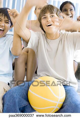 Group of high school students sitting with basketball, cheering View Large Photo Image Stock Photo - Group of high school students sitting with basketball, cheering. Fotosearch