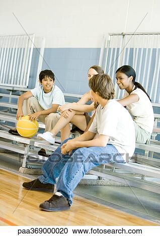 Group of teens sitting with basketball on bleachers in school gym View Large Photo Image Stock Image - Group of teens sitting with basketball on bleachers in school gym. Fotosearch