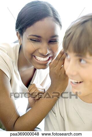 Teen girl whispering to teen boy View Large Photo Image Stock Photo - Teen girl whispering to teen boy. Fotosearch