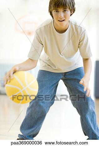 Teenage boy playing basketball View Large Photo Image Stock Photograph - Teenage boy playing basketball. Fotosearch