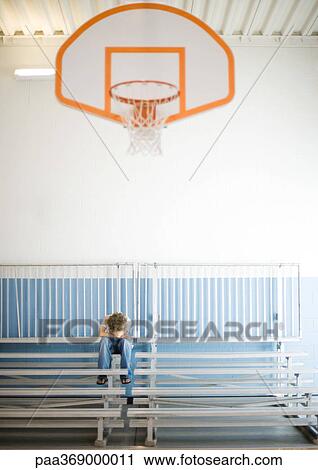 Teenage boy sitting alone with head down in school gym View Large Photo Image Stock Image - Teenage boy sitting alone with head down in school gym. Fotosearch
