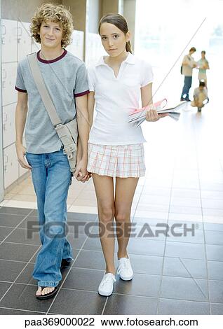 Teenage couple walking through hallway of high school View Large Photo Image Stock Image - Teenage couple walking through hallway of high school. Fotosearch
