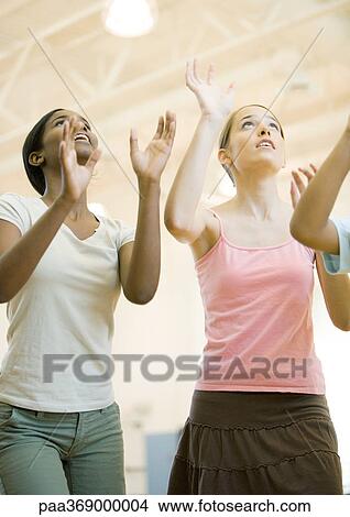 Teenage girls holding arms up to hit ball View Large Photo Image Picture - Teenage girls holding arms up to hit ball. Fotosearch