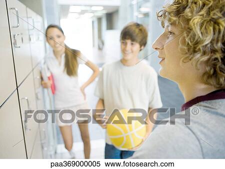 Stock Photography - Teenagers talking near lockers. Fotosearch