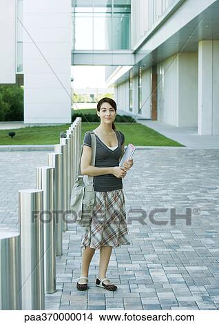 Picture - Female college student standing on campus. Fotosearch