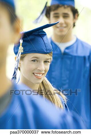 Graduates in line, smiling, focus on young woman View Large Photo Image Stock Photo - Graduates in line, smiling, focus on young woman. Fotosearch