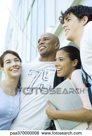 Stock Photo - Group of college students standing close together, smiling. Fotosearch