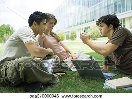 Group of college students studying in grass View Large Photo Image Stock Photograph - Group of college students studying in grass. Fotosearch