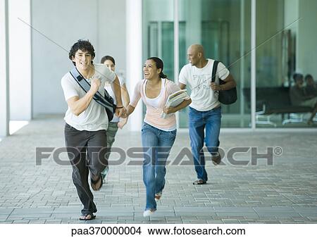 Picture - Group of students running on campus. Fotosearch