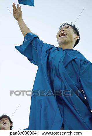Male graduate throwing cap View Large Photo Image Stock Image - Male graduate throwing cap. Fotosearch