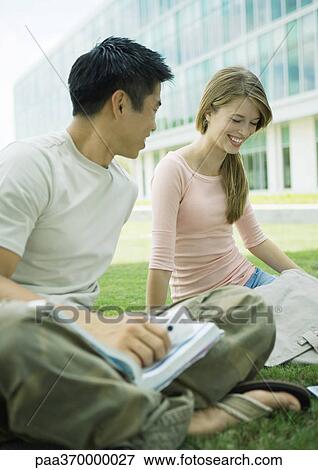 Two college students sitting on ground, studying View Large Photo Image Stock Photo - Two college students sitting on ground, studying. Fotosearch