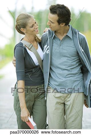 Young couple walking View Large Photo Image Stock Photograph - Young couple walking. Fotosearch