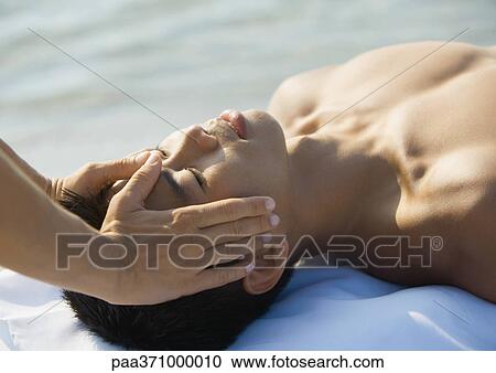 Stock Image - Man having head massage. Fotosearch