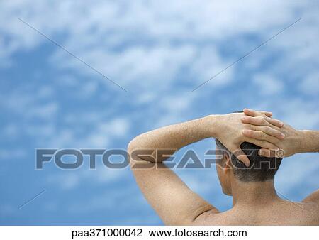 Man with hands behind head, looking at sky, rear view View Large Photo Image Stock Image - Man with hands behind head, looking at sky, rear view. Fotosearch
