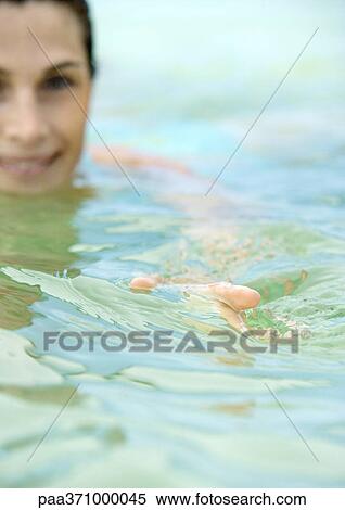 Stock Photography - Woman in water, focus on hand in foreground. Fotosearch