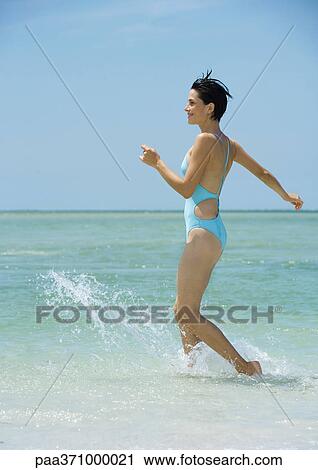 Woman running in surf View Large Photo Image Stock Image - Woman running in surf. Fotosearch