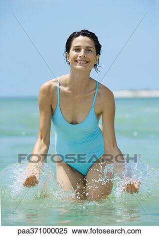 Woman splashing in water View Large Photo Image Stock Photography - Woman splashing in water. Fotosearch