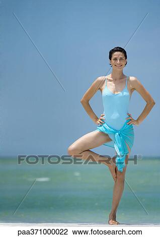 Woman standing in tree pose on beach View Large Photo Image Stock Image - Woman standing in tree pose on beach. Fotosearch