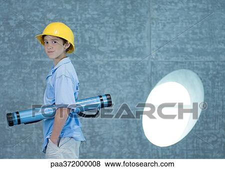 Stock Photo - Boy holding document tube under arm and wearing hard hat. Fotosearch