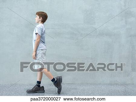 Boy walking in oversized shoes View Large Photo Image Stock Photo - Boy walking in oversized shoes. Fotosearch