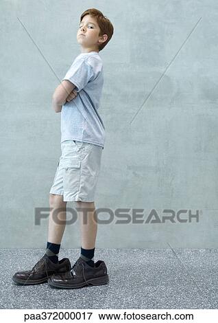 Boy wearing men's shoes View Large Photo Image Stock Photo - Boy wearing men's shoes. Fotosearch
