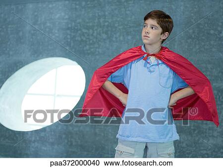 Boy wearing red cape, hands on hips View Large Photo Image Stock Image - Boy wearing red cape, hands on hips. Fotosearch