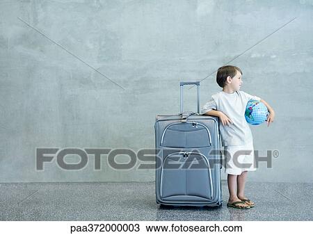 Stock Image - Boy with suitcase and globe. Fotosearch