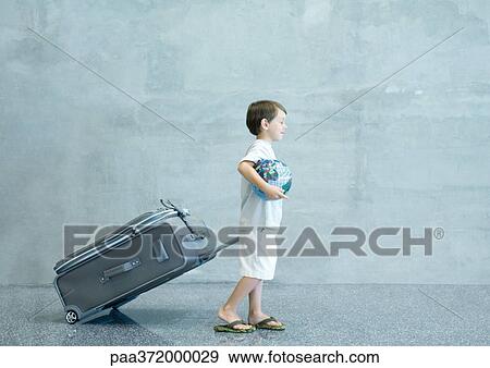 Boy with suitcase and globe View Large Photo Image Stock Photo - Boy with suitcase and globe. Fotosearch