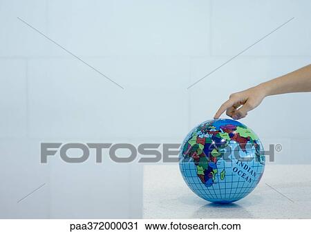 Child's hand pointing to spot on globe View Large Photo Image Stock Image - Child's hand pointing to spot on globe. Fotosearch